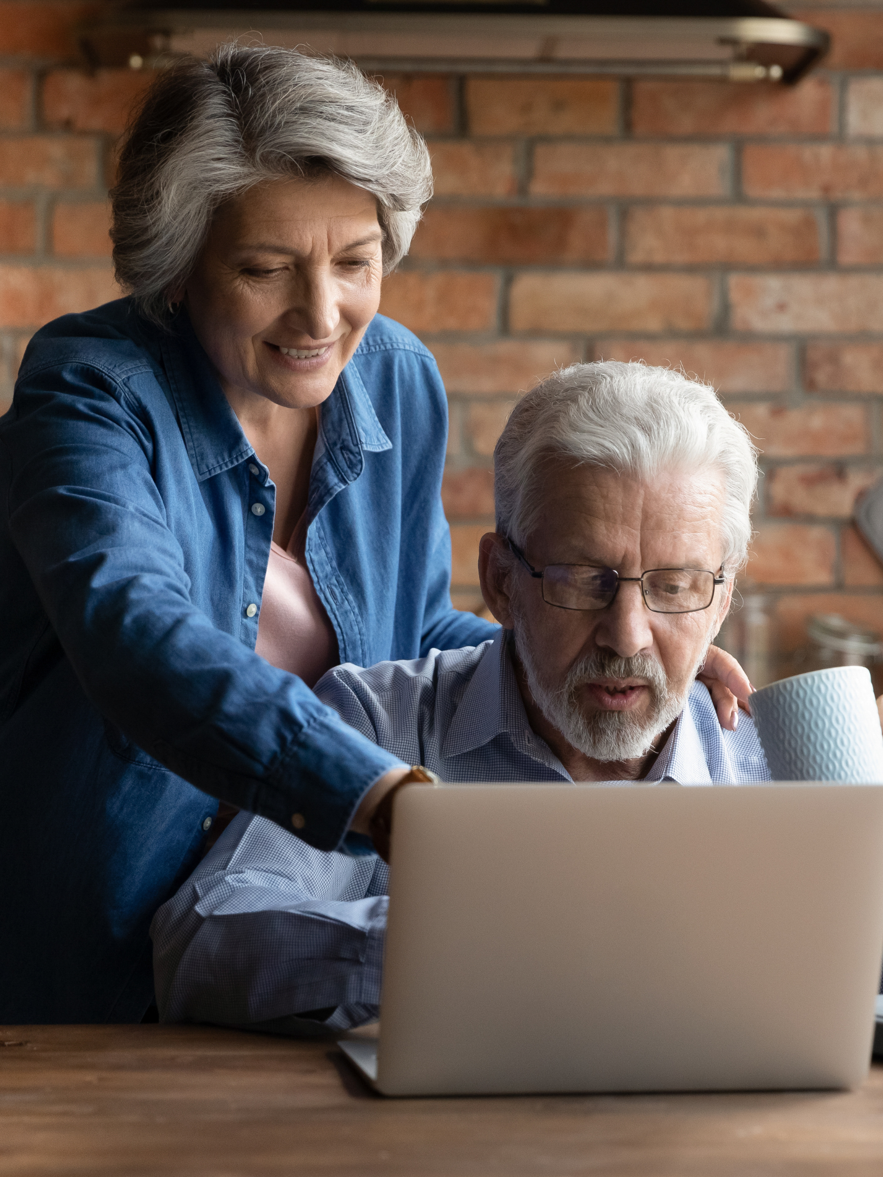 Trust & Will Happy middle aged family couple using computer.